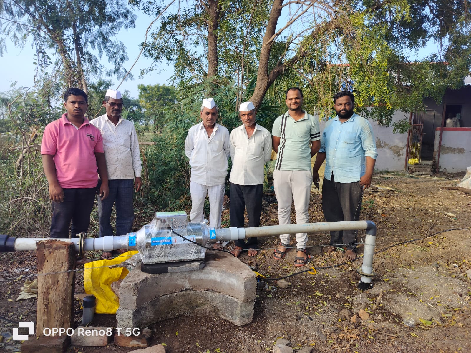 Field installation of water conditioning device with farmers and technical support team
